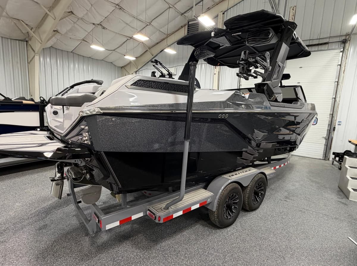 Black Nautique wakeboard boat with tinted windshield