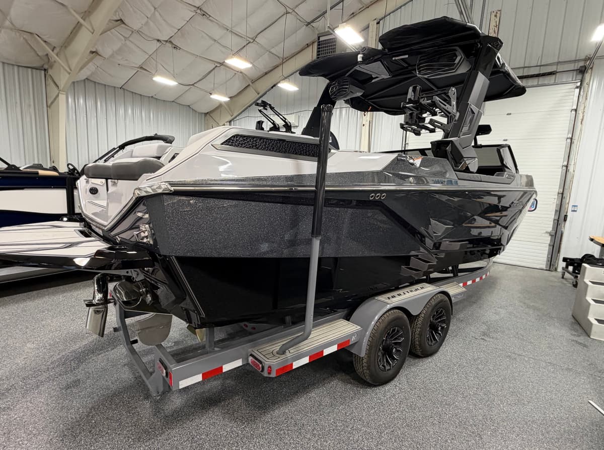 Black Nautique wakeboard boat with tinted windshield